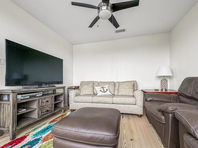 living room with ceiling fan and hardwood / wood-style floors