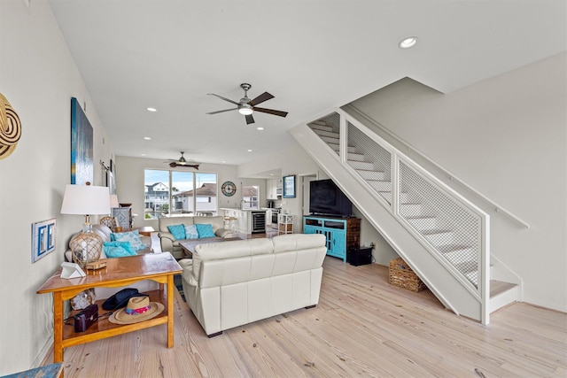 living room featuring ceiling fan and light wood-type flooring