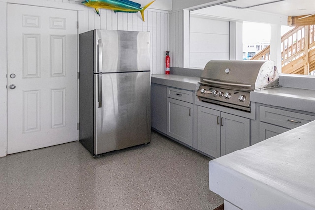 kitchen with gray cabinets and stainless steel fridge