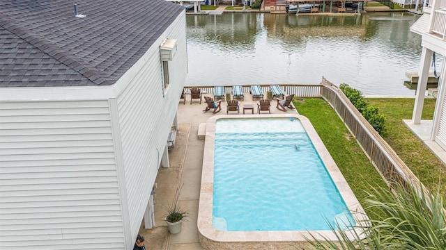 view of pool featuring a water view and a patio