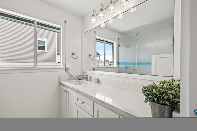 bathroom with vanity and a shower with shower door