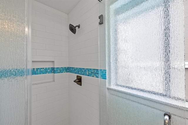 bathroom with tiled shower