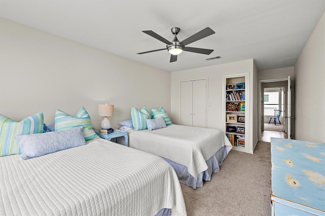 bedroom featuring a closet, light colored carpet, and ceiling fan