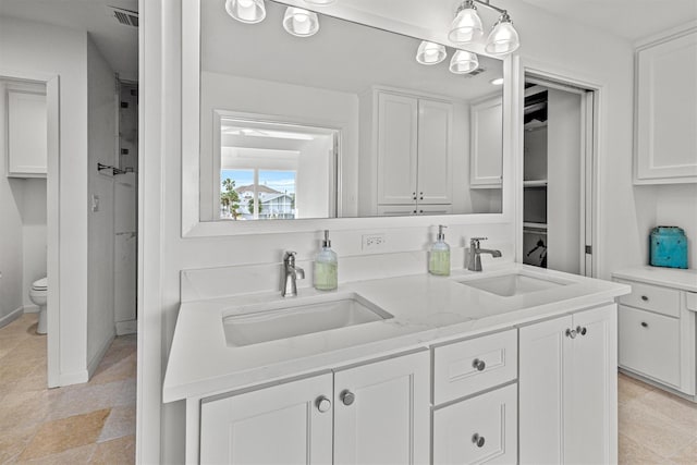 kitchen with white cabinets, sink, and hanging light fixtures