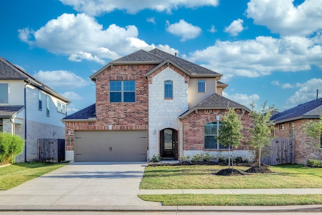 view of front of house featuring a front yard and a garage