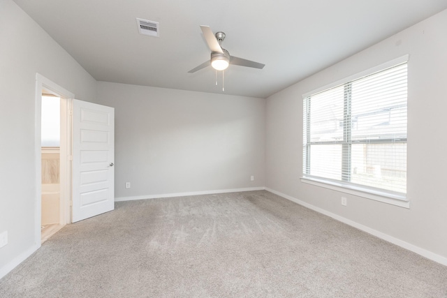 carpeted spare room with ceiling fan