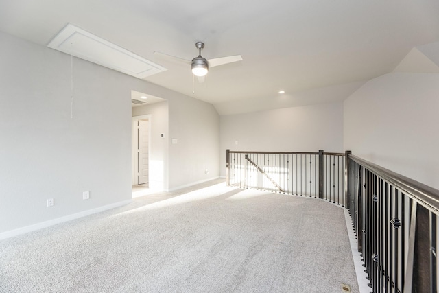 carpeted empty room featuring ceiling fan and vaulted ceiling