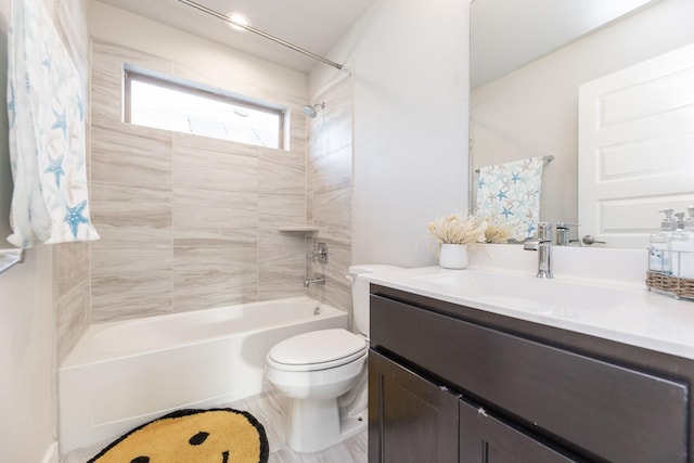 full bathroom with vanity, toilet, and tiled shower / bath