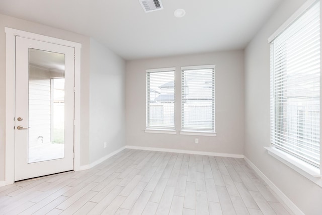 spare room featuring light wood-type flooring