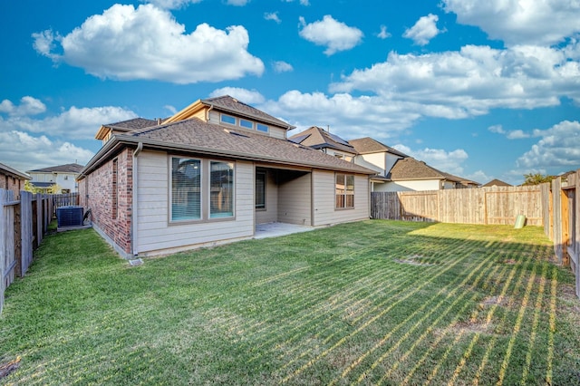 rear view of house featuring central AC unit, a patio, and a lawn