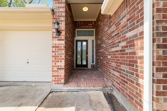 entrance to property featuring french doors and a garage