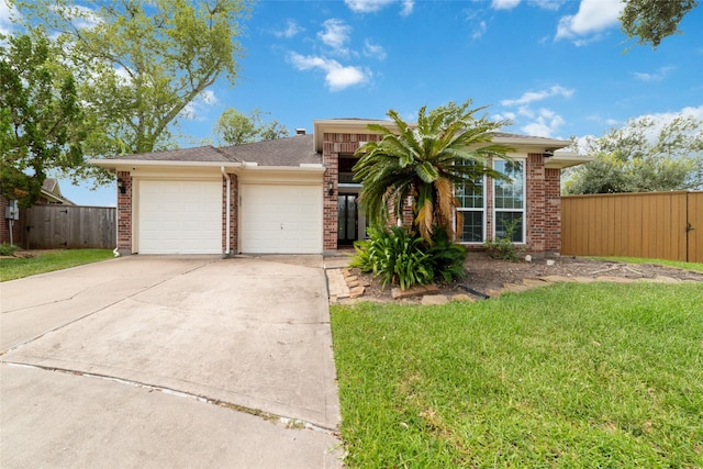 single story home featuring a front yard and a garage