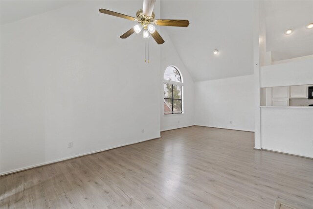 unfurnished living room with light hardwood / wood-style flooring, high vaulted ceiling, and ceiling fan