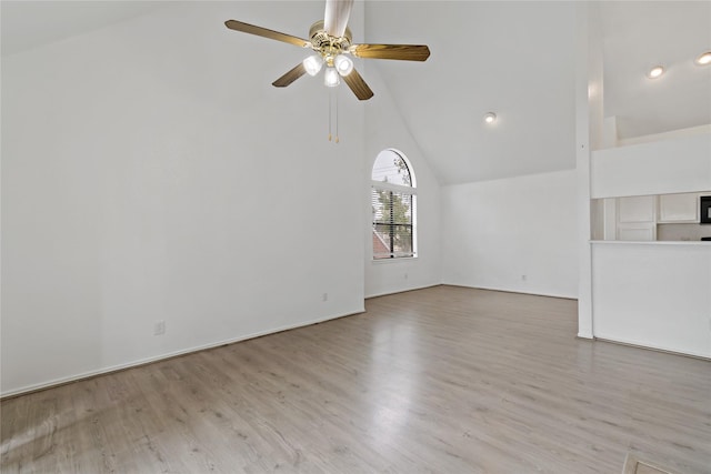 unfurnished living room featuring high vaulted ceiling, light hardwood / wood-style floors, and ceiling fan