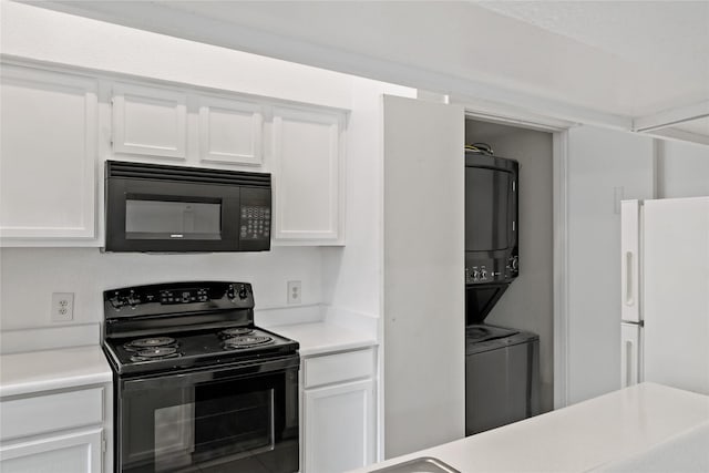 kitchen with white cabinets, stacked washer and clothes dryer, and black appliances