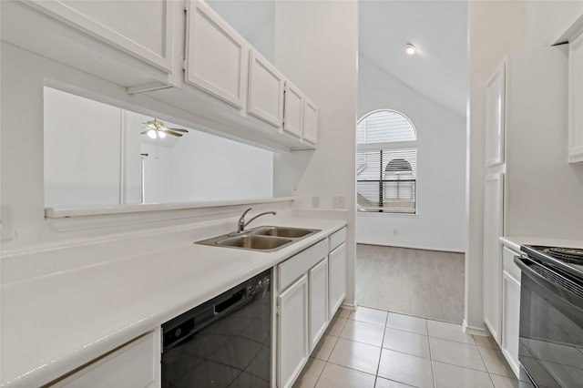 kitchen featuring lofted ceiling, sink, black appliances, light tile patterned floors, and white cabinets