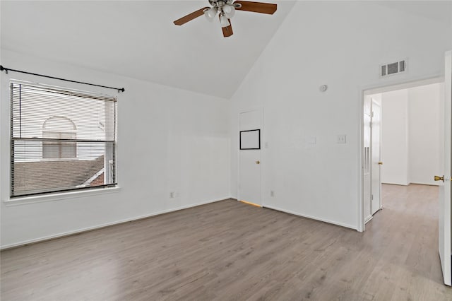 spare room with ceiling fan, high vaulted ceiling, and light hardwood / wood-style floors