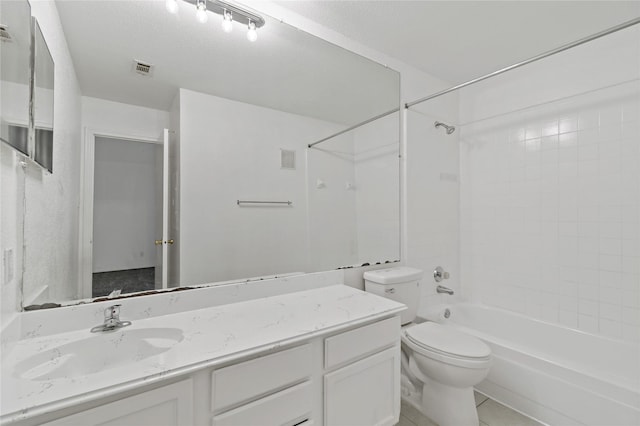 full bathroom with tiled shower / bath, vanity, a textured ceiling, and toilet