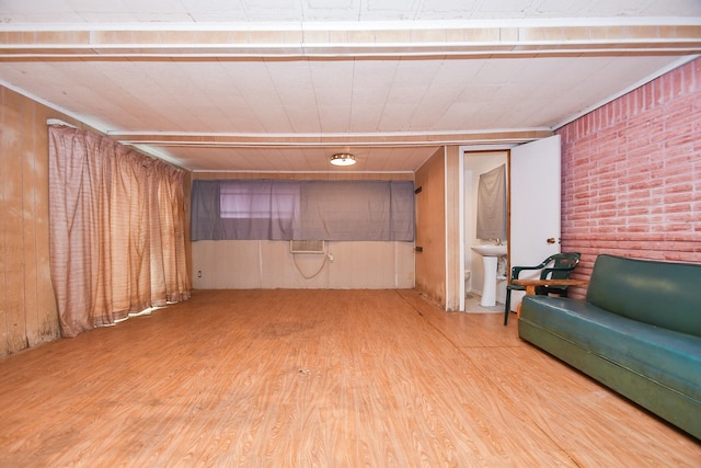 basement featuring wood walls and wood-type flooring