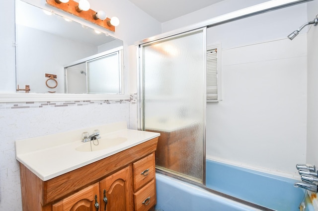 bathroom with shower / bath combination with glass door and vanity