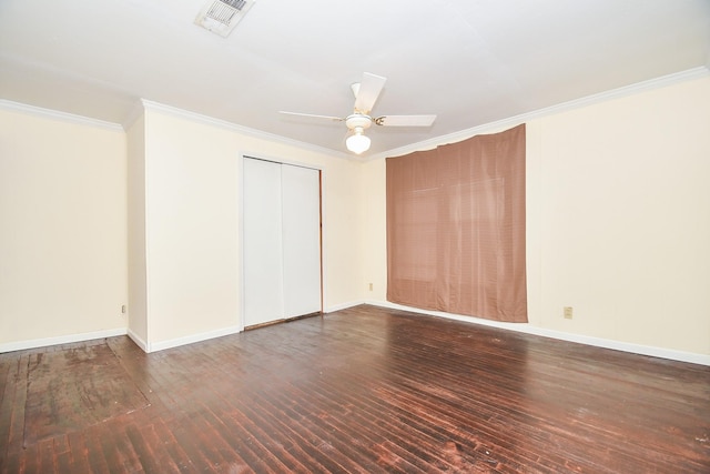 unfurnished room featuring ornamental molding, ceiling fan, and dark wood-type flooring