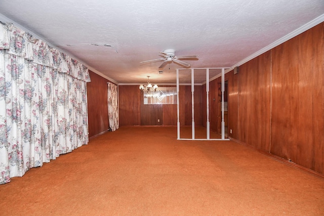 basement with a textured ceiling, wood walls, carpet floors, and crown molding