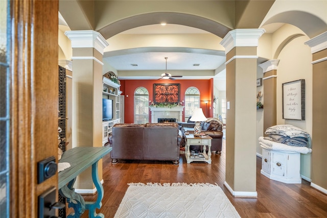 interior space featuring ceiling fan, ornate columns, and dark hardwood / wood-style floors