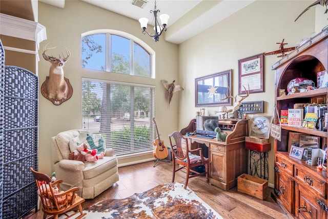 office featuring light hardwood / wood-style flooring and a notable chandelier