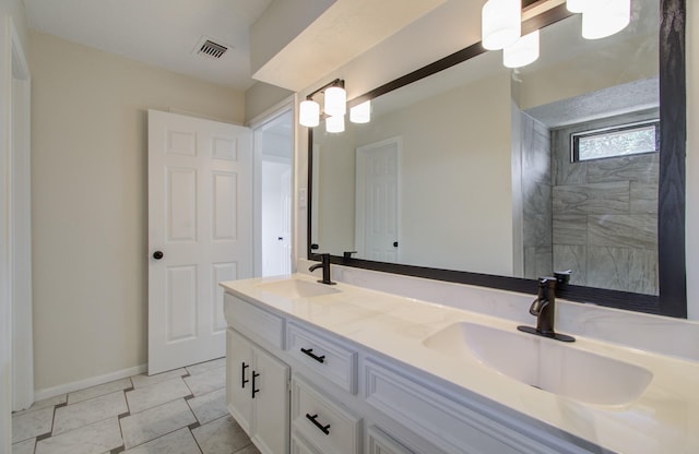 bathroom featuring tile patterned flooring and vanity