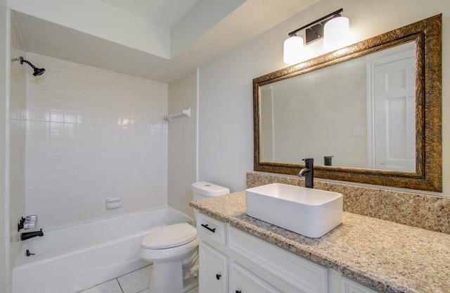 full bathroom with vanity, tiled shower / bath, tile patterned flooring, toilet, and a textured ceiling