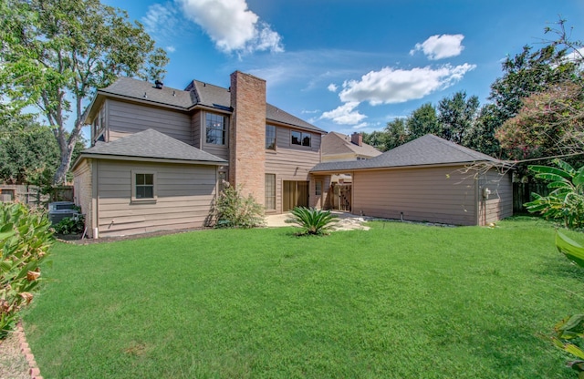 rear view of house featuring a yard