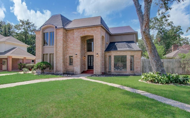 french country style house featuring a front lawn