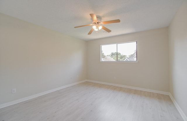 unfurnished room featuring ceiling fan, light wood-type flooring, and a textured ceiling