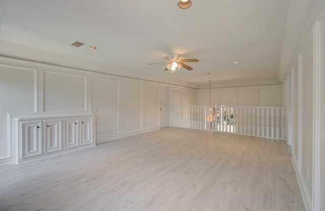 unfurnished room with ceiling fan and light wood-type flooring