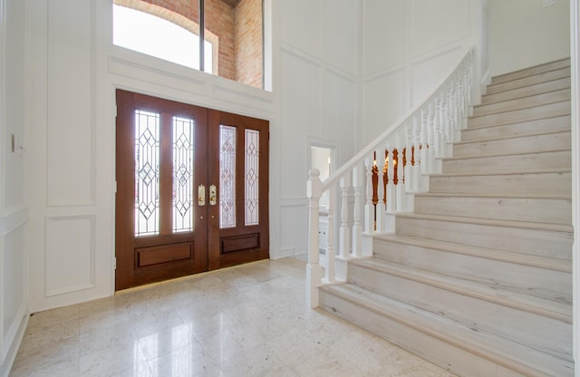 entryway with a towering ceiling