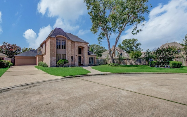 view of front of property featuring a garage and a front yard