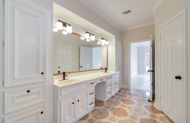 bathroom with tile patterned floors, crown molding, and vanity