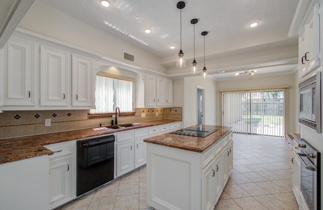 kitchen with a center island, black appliances, sink, decorative backsplash, and white cabinetry