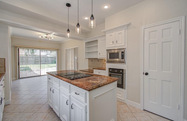 kitchen featuring white cabinetry, a center island, stainless steel appliances, backsplash, and light tile patterned floors