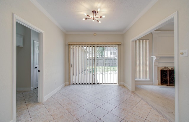 unfurnished room with light tile patterned floors, a textured ceiling, crown molding, and a notable chandelier