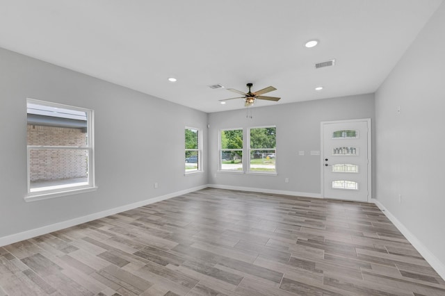 unfurnished room featuring light hardwood / wood-style floors and ceiling fan