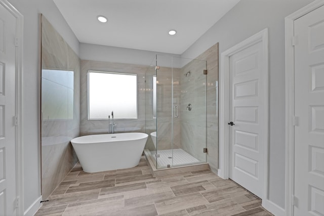 bathroom featuring separate shower and tub