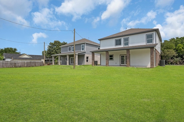 back of house with a yard and central air condition unit