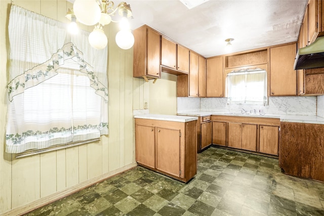 kitchen featuring a chandelier, sink, and tasteful backsplash