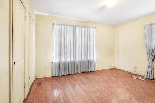 unfurnished bedroom with light hardwood / wood-style floors and a closet