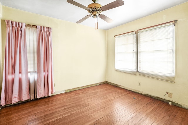 spare room with hardwood / wood-style floors and ceiling fan