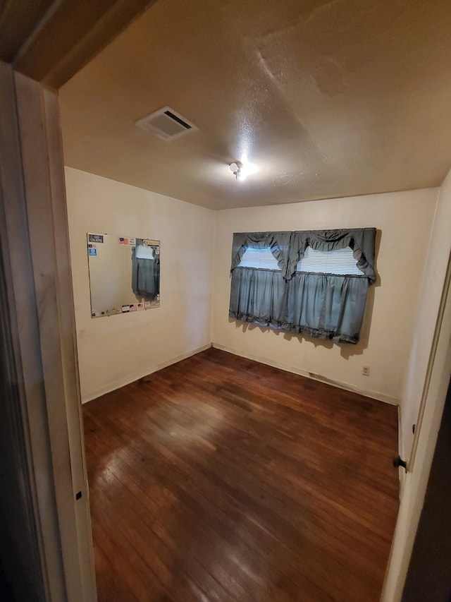 empty room with dark hardwood / wood-style floors