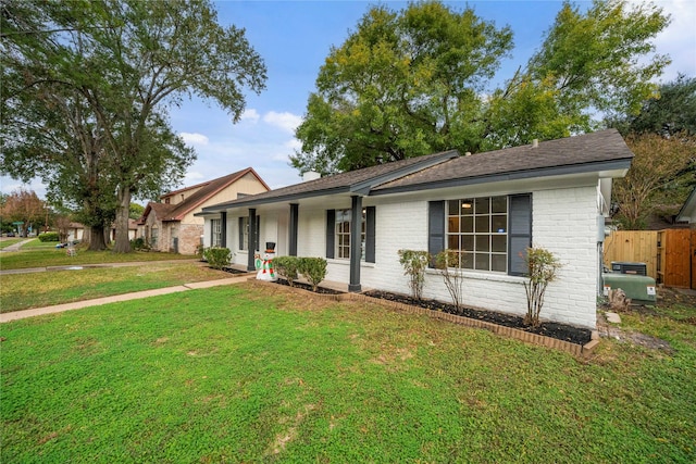 single story home featuring covered porch and a front lawn