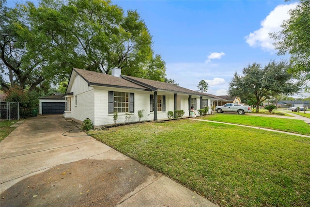 ranch-style house featuring covered porch, a garage, a front lawn, and an outdoor structure