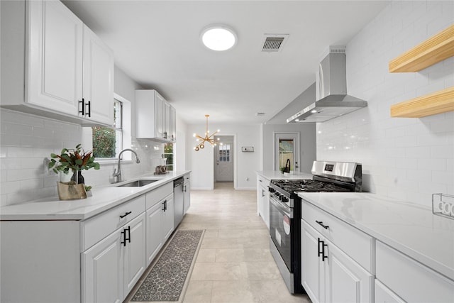 kitchen with sink, white cabinets, wall chimney range hood, and appliances with stainless steel finishes